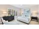 A light filled bedroom with a tufted headboard and plantation shutters for privacy and style at 11116 Sanctuary Dr, Bradenton, FL 34209