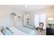 Comfortable bedroom with a chair and view of living area from the ensuite entrance at 11116 Sanctuary Dr, Bradenton, FL 34209