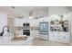 Bright kitchen with white cabinets, stainless steel appliances, and stylish decor at 11116 Sanctuary Dr, Bradenton, FL 34209