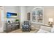 Inviting living room features shuttered windows, neutral paint and modern decor at 11116 Sanctuary Dr, Bradenton, FL 34209