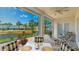 Screened patio with comfortable seating area and views of the serene lake and landscaping at 11116 Sanctuary Dr, Bradenton, FL 34209