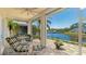 Relaxing screened patio with a dining set and scenic waterfront views at 11116 Sanctuary Dr, Bradenton, FL 34209