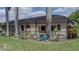Landscaped backyard with pool, covered patio, lush plants, and outdoor entertaining area at 11592 57Th Street E Cir, Parrish, FL 34219