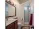 Cozy bathroom featuring a spacious vanity, toilet, and a walk-in shower with glass doors at 11592 57Th Street E Cir, Parrish, FL 34219