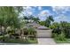 Charming single-story home featuring lush landscaping, a brick driveway, and an attached two-car garage at 11592 57Th Street E Cir, Parrish, FL 34219