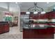 Open concept kitchen with stainless steel fridge, granite countertops, and adjacent dining area at 11592 57Th Street E Cir, Parrish, FL 34219