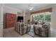 Comfortable living room offers a neutral color palette, tile flooring, and sliding glass doors to the screened lanai at 11592 57Th Street E Cir, Parrish, FL 34219