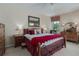Warm bedroom with matching bedside tables, dressers, and a wrought iron bed at 11592 57Th Street E Cir, Parrish, FL 34219