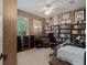A home office with bookcases, a work space, and a view to the outdoors at 11592 57Th Street E Cir, Parrish, FL 34219