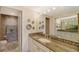 Bathroom featuring a granite countertop vanity, decorative mirrors, and access to the water closet at 1212 Benjamin Franklin Dr # 503, Sarasota, FL 34236