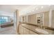 Bathroom featuring dual sinks, granite counters, vanity lighting, and large mirror at 1212 Benjamin Franklin Dr # 503, Sarasota, FL 34236