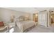 Comfortable bedroom with a ceiling fan, neutral tones, and access to an ensuite bathroom at 1212 Benjamin Franklin Dr # 503, Sarasota, FL 34236