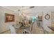 Elegant dining room featuring a chandelier and a mirrored wall reflecting the view from the balcony at 1212 Benjamin Franklin Dr # 503, Sarasota, FL 34236