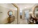 Inviting hallway with decorative mirrors and elegant furnishings leading to the living area at 1212 Benjamin Franklin Dr # 503, Sarasota, FL 34236