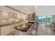 Well-appointed kitchen with white cabinetry, granite countertops, and a breakfast bar with a view of the balcony at 1212 Benjamin Franklin Dr # 503, Sarasota, FL 34236