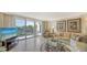 Spacious living room with a large sliding glass door that leads to a balcony offering panoramic ocean views at 1212 Benjamin Franklin Dr # 503, Sarasota, FL 34236