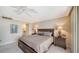 Inviting main bedroom featuring a ceiling fan, two side tables with lamps, and neutral tones at 1212 Benjamin Franklin Dr # 503, Sarasota, FL 34236