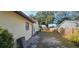 Backyard shows the exterior, including the wooden fence and some trees in the background at 1218 Carmella Ln, Sarasota, FL 34243