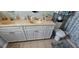 Bathroom with double sinks, white cabinets and ample counter space at 1218 Carmella Ln, Sarasota, FL 34243