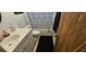 Well-lit bathroom with a vanity, toilet, and shower/tub combo featuring a black mat and patterned shower curtain at 1218 Carmella Ln, Sarasota, FL 34243