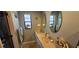 Bathroom with double sinks, vanity, framed mirrors and ample counter space at 1218 Carmella Ln, Sarasota, FL 34243