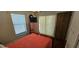 Bedroom features a wooden bed, wood blinds, and a dresser with television at 1218 Carmella Ln, Sarasota, FL 34243