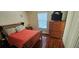 Comfortable bedroom with a wooden bed, wooden dresser with a TV, and a window at 1218 Carmella Ln, Sarasota, FL 34243