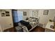 Cozy bedroom with a decorative black and white bedding set and hardwood floors at 1218 Carmella Ln, Sarasota, FL 34243