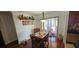 Charming dining area with a wooden table set for a meal, adjacent to sliding doors that lead to the outside at 1218 Carmella Ln, Sarasota, FL 34243