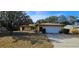 Charming single story home with two-car garage and mature trees shading the front yard at 1218 Carmella Ln, Sarasota, FL 34243