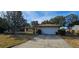 Single Gathering home features a large two-car garage and a well-kept lawn at 1218 Carmella Ln, Sarasota, FL 34243