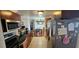Galley kitchen with stainless appliances and granite countertops, open to the dining area and the living room at 1218 Carmella Ln, Sarasota, FL 34243
