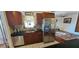 Functional kitchen with stainless steel appliances and ample cabinet space, connected to a cozy living area at 1218 Carmella Ln, Sarasota, FL 34243
