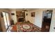 Cozy living room features a stone fireplace, wood floors, and sliding glass doors to the exterior at 1218 Carmella Ln, Sarasota, FL 34243