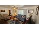 Cozy living room featuring a comfortable sofa, a decorative area rug, and a large window for natural light at 1218 Carmella Ln, Sarasota, FL 34243