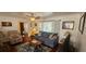 Comfortable living room boasts ample seating, a decorative area rug, and a bright, airy feel at 1218 Carmella Ln, Sarasota, FL 34243