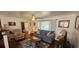 Inviting living room with a comfortable sofa, a cozy armchair, and a decorative area rug at 1218 Carmella Ln, Sarasota, FL 34243