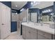 Chic bathroom with blue walls, double vanity, and glass-enclosed shower stall at 12706 Cobalt Ter, Bradenton, FL 34211