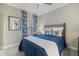 Cozy bedroom featuring a blue and white color scheme, carpet, and a patterned accent pillow at 12706 Cobalt Ter, Bradenton, FL 34211