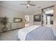 Comfortable bedroom with a ceiling fan, plush carpet, and a view into the bathroom and living area at 12706 Cobalt Ter, Bradenton, FL 34211