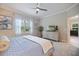 Tranquil bedroom featuring a ceiling fan, soft gray carpet, and large windows for ample natural light at 12706 Cobalt Ter, Bradenton, FL 34211