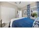 Bedroom features a large window, plantation shutters, and blue coastal decor at 12706 Cobalt Ter, Bradenton, FL 34211