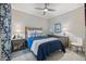 Cozy bedroom featuring a wicker headboard, blue bedding, and stylish nautical decor at 12706 Cobalt Ter, Bradenton, FL 34211