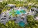 Aerial shot of a large community pool with cabanas and lush tropical landscaping at 12706 Cobalt Ter, Bradenton, FL 34211