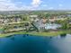 Beautiful community pool and clubhouse surrounded by a lake, lush landscaping, and swaying palm trees at 12706 Cobalt Ter, Bradenton, FL 34211