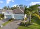 Home exterior featuring a three car garage, and meticulously landscaped yard at 12706 Cobalt Ter, Bradenton, FL 34211
