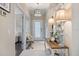 Inviting foyer with tiled floors, decorative lamps on a rustic table, and a glimpse into the living room with comfortable seating at 12706 Cobalt Ter, Bradenton, FL 34211