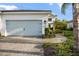 A well-kept home featuring a light blue two car garage door, clean landscaping, and a brick paver driveway and walkway at 12706 Cobalt Ter, Bradenton, FL 34211