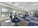 Bright gym with rows of treadmills, elliptical machines, weights and windows allowing ample natural light at 12706 Cobalt Ter, Bradenton, FL 34211