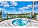 Community hot tub with views of the lake and clear blue skies, offering a relaxing outdoor amenity at 12706 Cobalt Ter, Bradenton, FL 34211